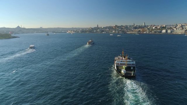 Ships floating Bosphorus blue water sunny day. Aerial drone view on sunset in Istanbul, Turkey