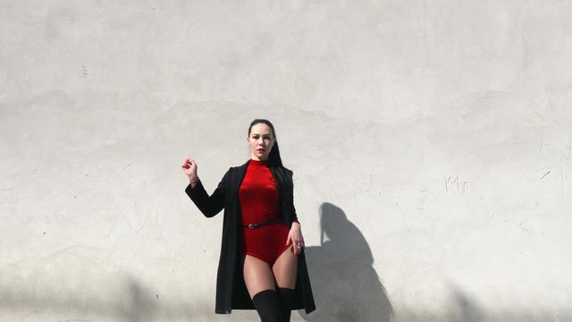 Sexy female dancer in Vogue and Waacking dance style dancing in the city with urban background.