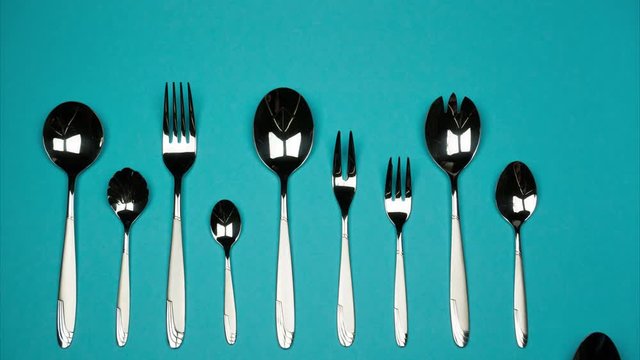 Forks and spoons of different sizes. Stop motion