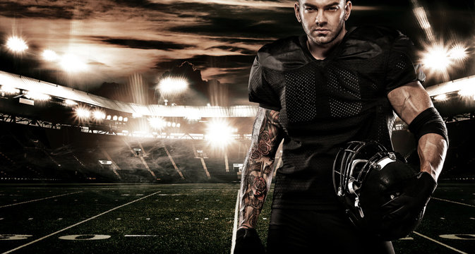 American football sportsman player on stadium. Sports banner and wallpaper with copyspace.