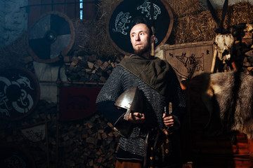 Fototapeta na wymiar Viking sword handles sword rack reenactment forge smith warrior weapon outfit ax shield skin hearth one man helmet