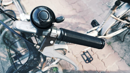 Hand grip black color and brake lever bicycles with old bell.  Components of the bicycle