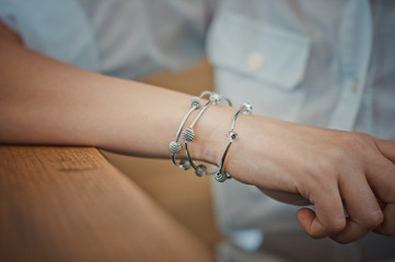 Female hand with three silver bracelets