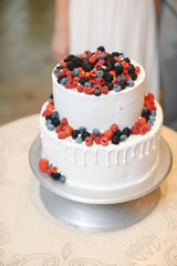 White wedding cake decorated with fresh berries