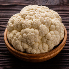 fresh cauliflower on a rustic wooden background