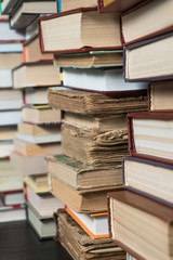 Many books in a bookstore or library on wooden background with copy space