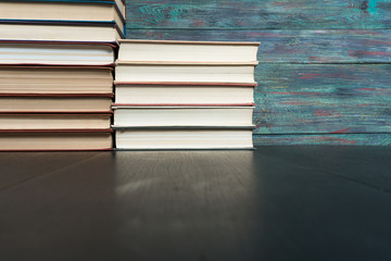 Stack books on wooden background. Back to school with copy space.