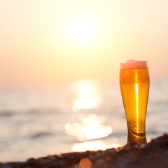 Glass of beer on a sunset