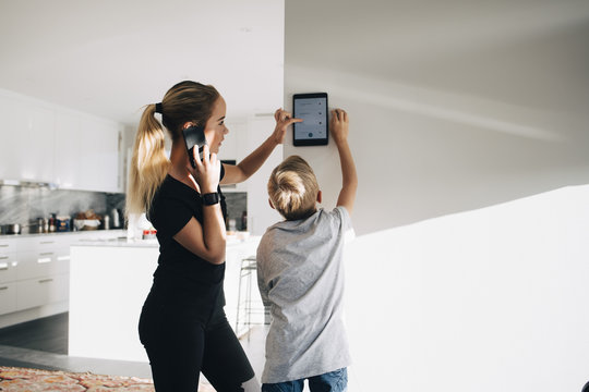 Brother and sister using smart home tablet