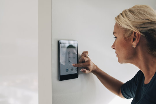 Woman using smart home tablet