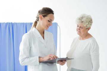 Smiling doctor consulting patient's results