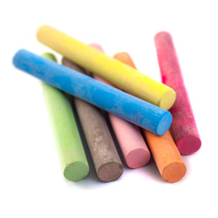 Colored chalks on white background with soft shadows