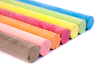 Colored chalks on white background with soft shadows