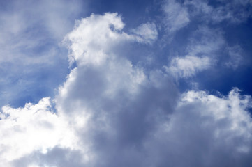 texture of a bright blue sky with one big cloud