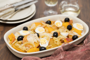 sweet potato with cod fish, onion and eggs on dish