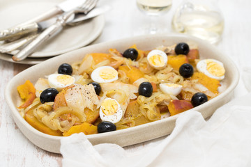 sweet potato with cod fish, onion and eggs on dish