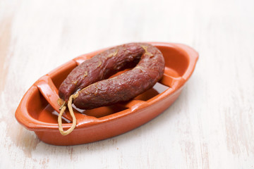 portuguese smoked sausage on brown ceramic dish