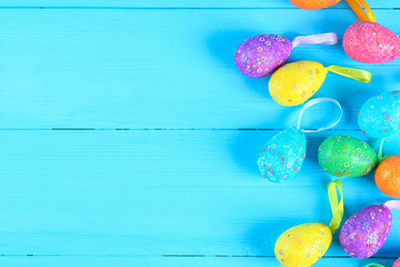 Colorful easter egg on blue pastel color wood background with space