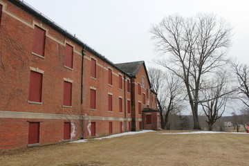 Fototapeta na wymiar Exterior of old brick abandoned historical mental asylum facility