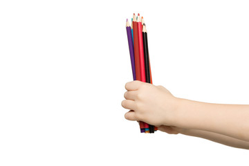 Children's hand holding colorful pencils, isolated