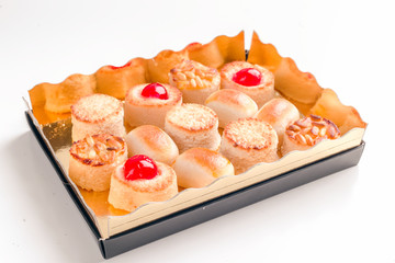 group of marzipan in golden box isolated on white