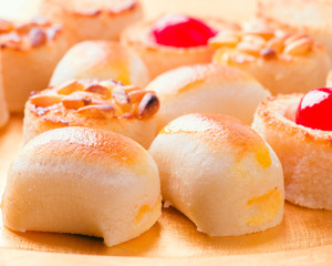 macro approach shot of marzipans in golden tray