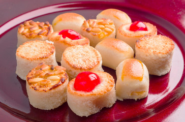 group of marzipan in red tray isolated on white