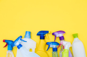 Spring cleaning spray bottle products on a bright yellow background