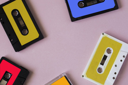 Retro cassette tape collection on pink background, top view. copy space.