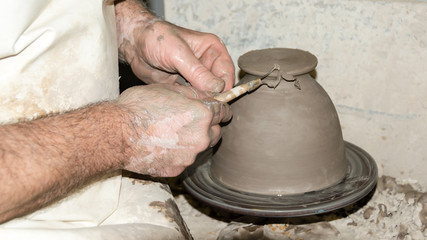 Fototapeta na wymiar photograph of making ceramic vases with ribbon tools in 16: 9 photo format