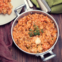 rice with fish and seafood in iron pot