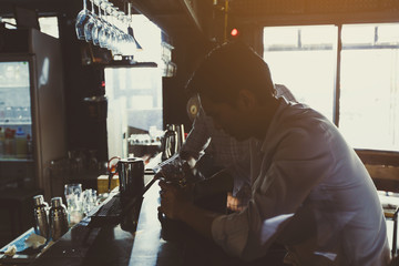 businessman relaxing and talking in nightclub ; two businessman drinking beverage in counter at nightclub.