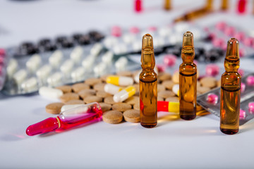On the table there are ampoules next different pills drugs and medications. With copy space for your text