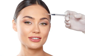 Portrait of an attractive young woman receiving botox treatment.