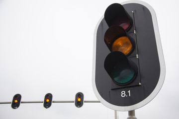 closeup of orange traffic lights and overcast sky