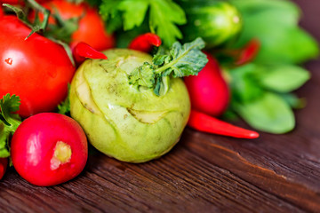 Fresh vegetables and herbs on wooden table