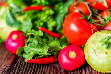 Fresh vegetables and herbs on wooden table