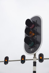 closeup of orange traffic lights and overcast sky