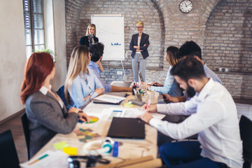 Business colleagues in conference meeting room during presentation