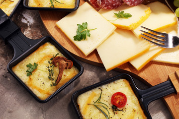 Delicious traditional Swiss melted raclette cheese on diced boiled or baked potato.