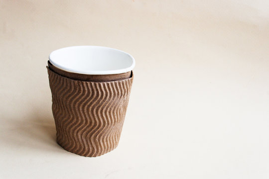 Disposable cup with corrugated paper. On a light paper  background.Candid.