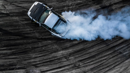 Aerial top view drifting car, Aerial view professional acceleration driver drifting car on asphalt race track, Extreme automobile sport for adrenaline. - obrazy, fototapety, plakaty
