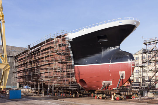 Hull of ship under construction at shipyard.