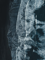 Aerial photograph ov waves entering black sand beach in Stokksnes, Iceland