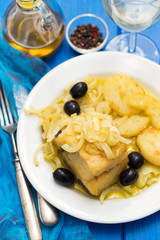 fried cod fish with onion and potato on white plate