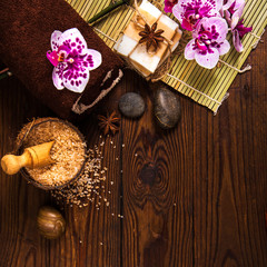 Spa concept with chocolate and candles on a wooden background.
