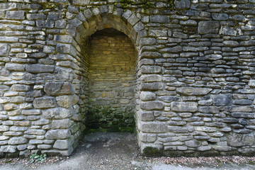 An ancient wall with an arch of stone built in the mountains of Gelendzhik