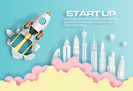Paper art style of rocket breaking through paper over modern city, start up business concept, flat-style vector illustration.