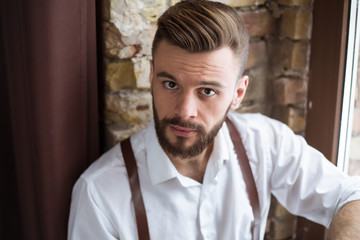 Happy portrait of smiling handsome bearded man in white shirt with very good mood.