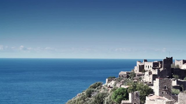 Greece Vatheia village. Architectural and historical old traditional abandoned tower houses in Vathia on Mani Peninsula. Laconia Peloponnese, Europe. Time lapse